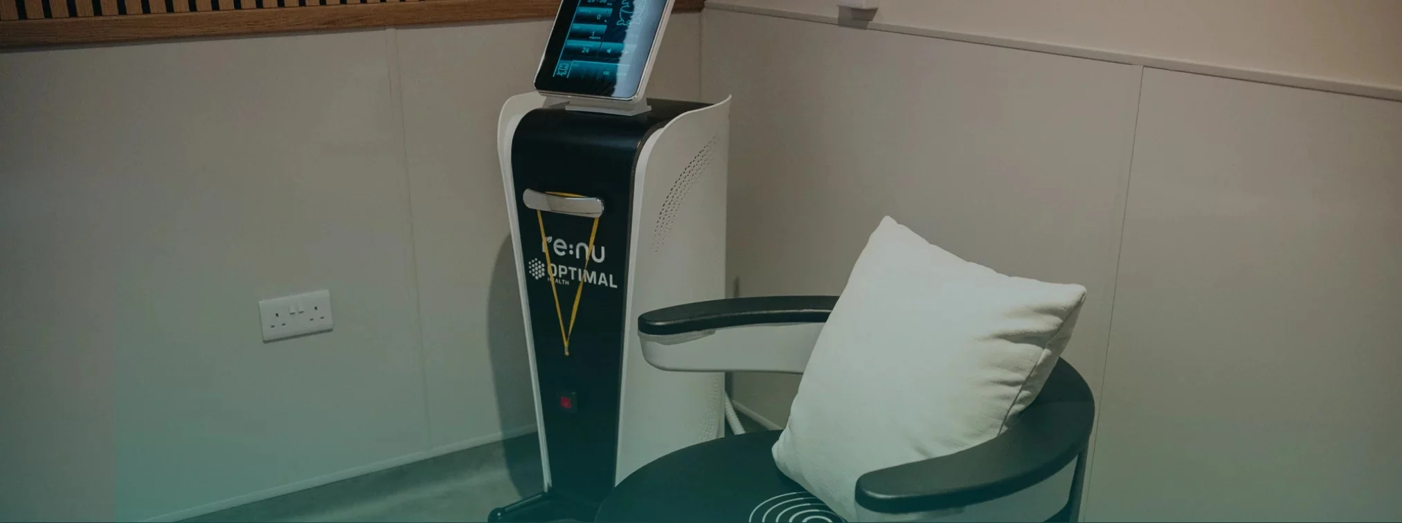Re:nu London's electromagnetic pelvic floor therapy chair and monitoring device with a green gradient overlay