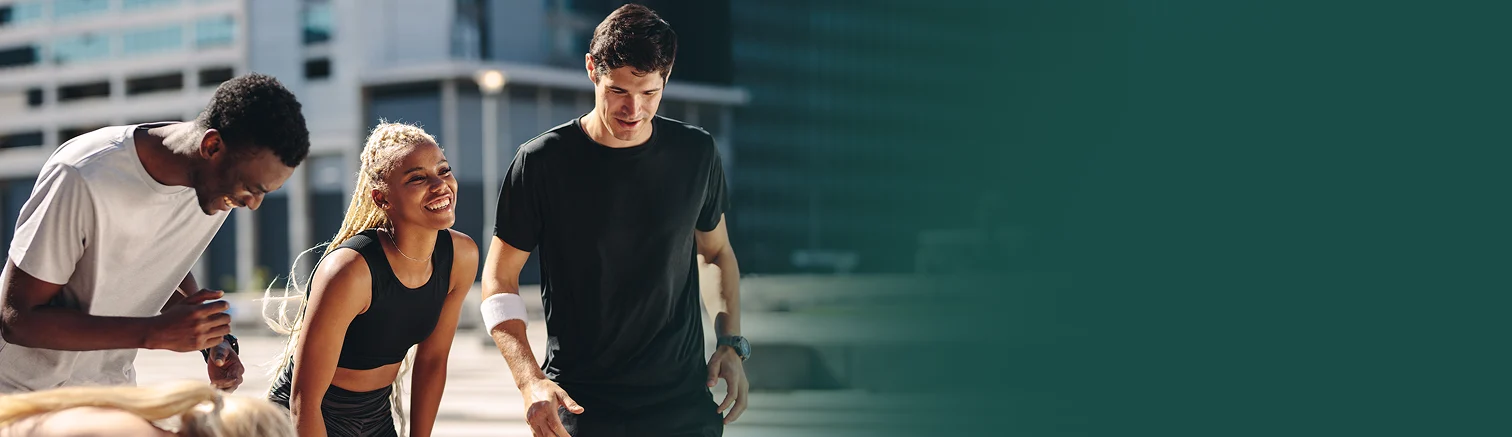 Three smiling young people in active wear