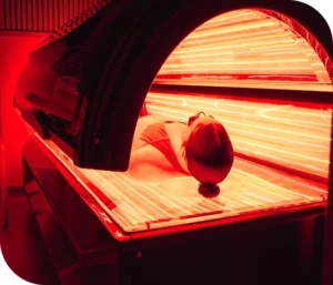 Woman lying down in a full-body red light therapy bed Woman lying down in a full-body red light therapy bed
