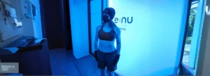 Cryotherapy (2) Woman wearing protective hat, gloves, and face masks prepares to enter a whole-body cryotherapy chamber at Re:nu London
