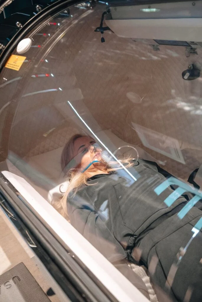 Woman lying down in a hyperbaric oxygen chamber