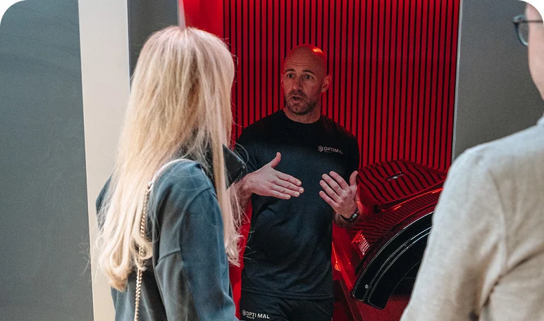 Wellness expert consulting two visitors on Re:nu London's biohacking treatments and facilities.