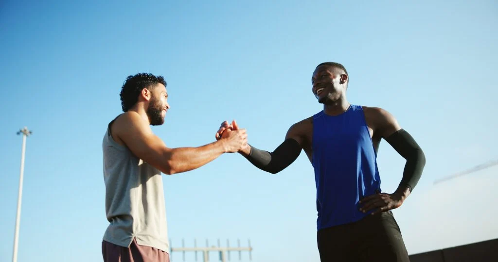 Happy,men,,fitness,and,city,with,handshake,for,teamwork,,meeting