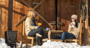 Two women unwinding outdoors in winter, highlighting recovery, immune resilience, and staying well throughout the winter season.