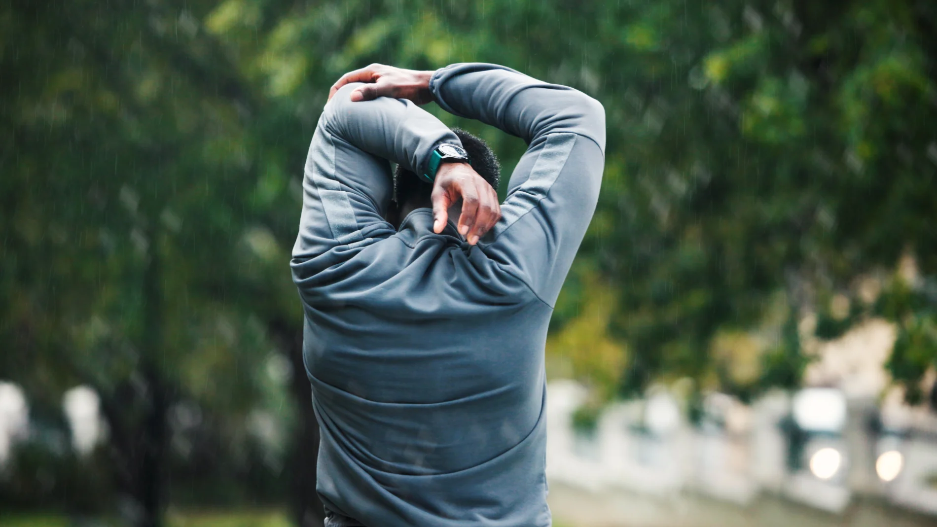 Man stretching his arms before an outdoor workout