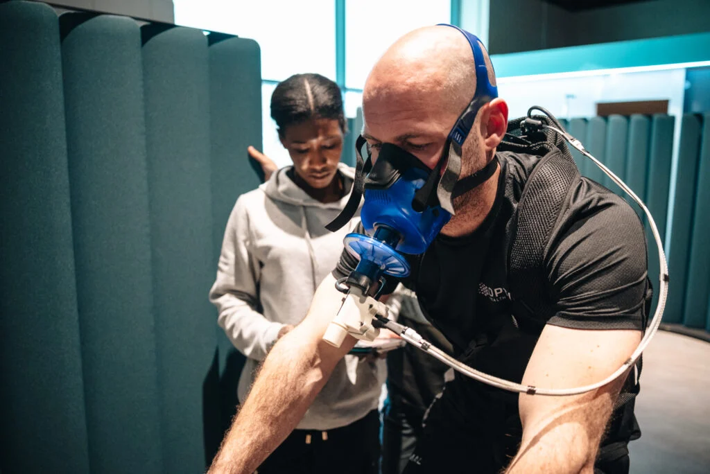 Customer undergoing a breath analysis health assessment at Re:nu Optimum Health Wellness Centre in Greenwich, London