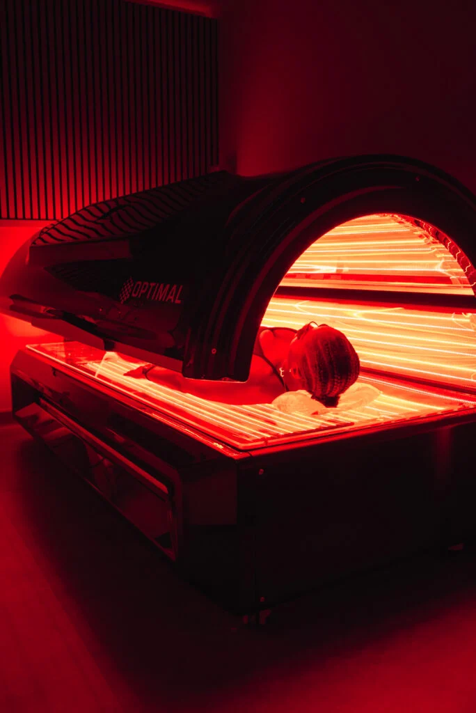 Re:nu London customer using a full-body red light therapy bed to alleviate joint aches and pains.