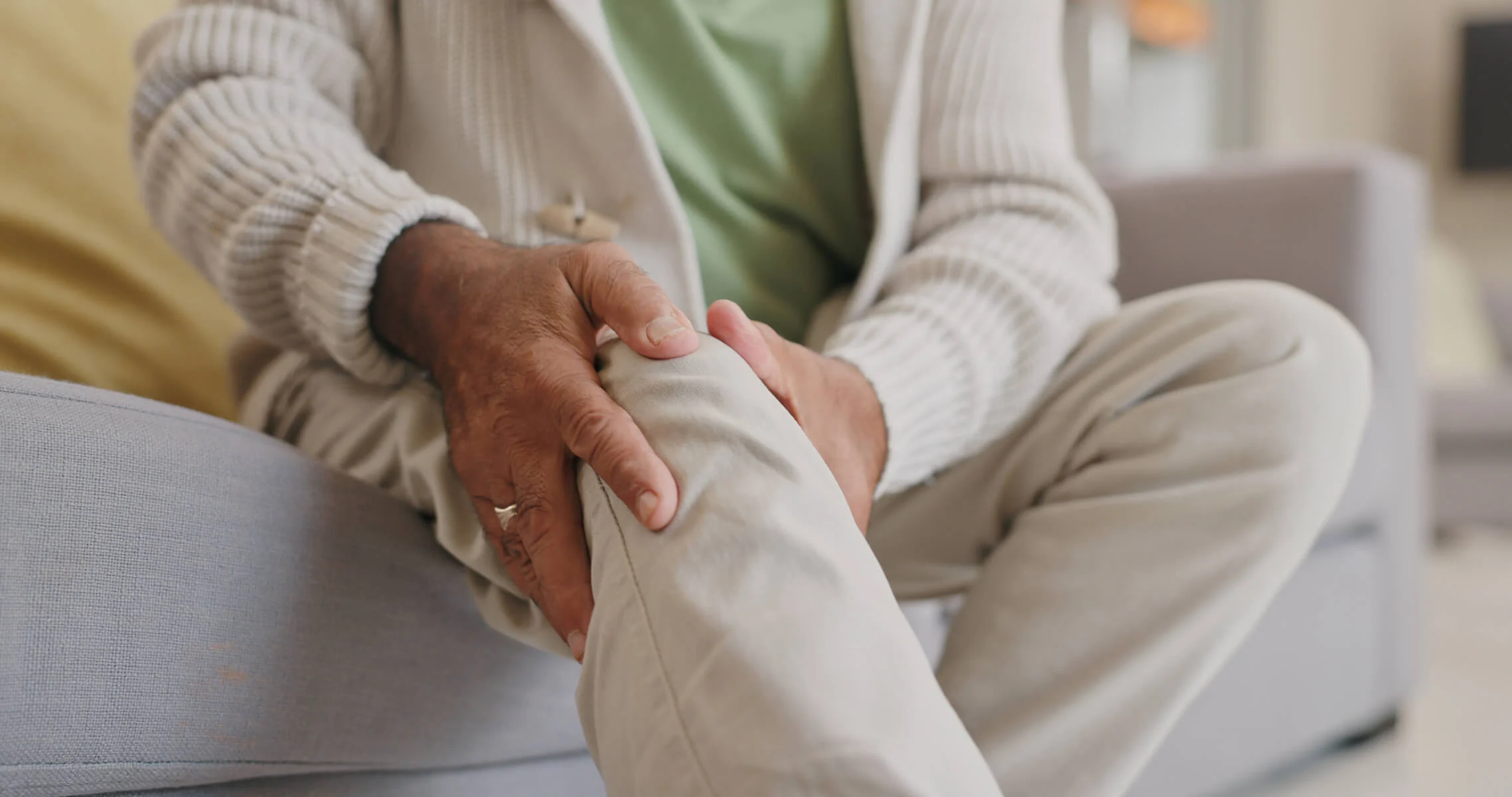 Older man clutching his knee due to joint pain Older man clutching his knee due to joint pain