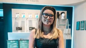Biohacking beginner customer smiling inside the Re:nu wellness centre in Greenwich, London.